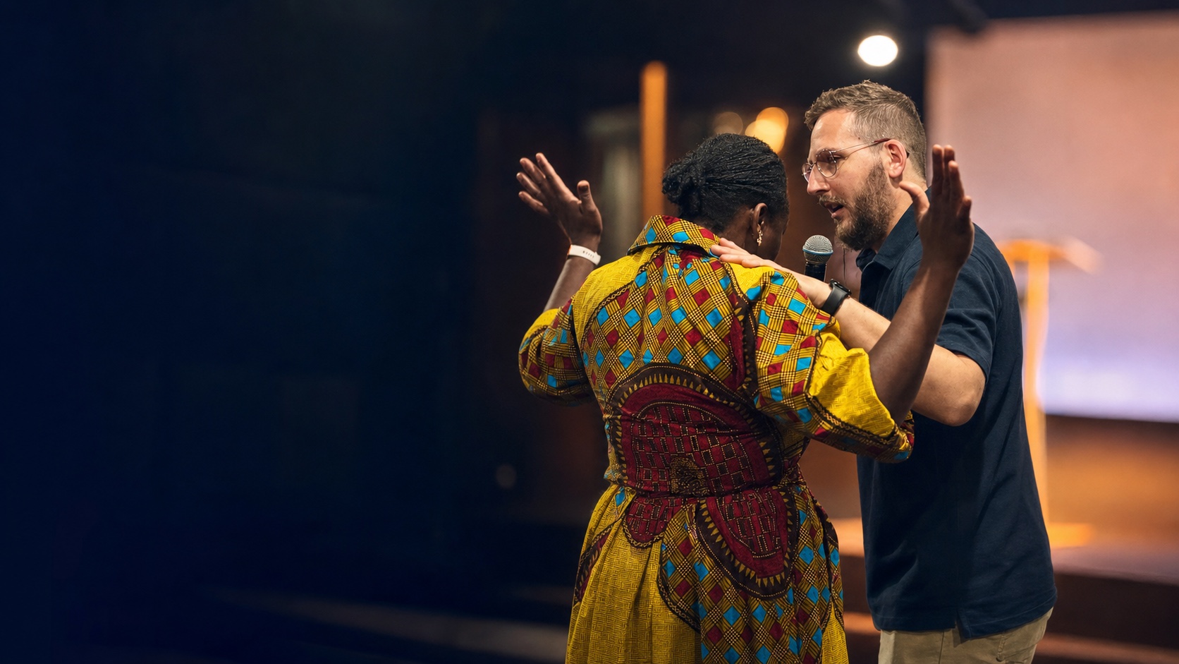 Andy Schofield praying with someone